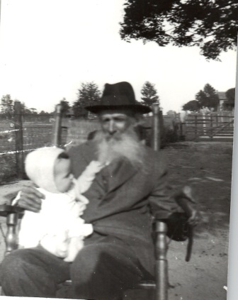 April 1927 - Addison Regan has his great-grandson, James Edward Lyle, in his lap in Colquitt Co, GA.